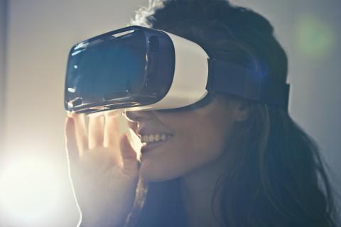 Woman wearing a virtual reality headset to view a virtual tour